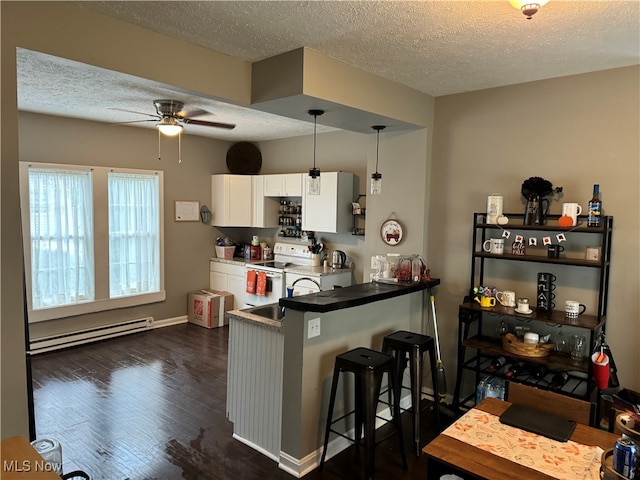 kitchen featuring dark hardwood / wood-style flooring, a breakfast bar, electric range, a baseboard radiator, and white cabinets