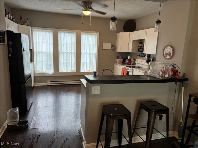 kitchen with white cabinets, a kitchen breakfast bar, and white range with electric cooktop