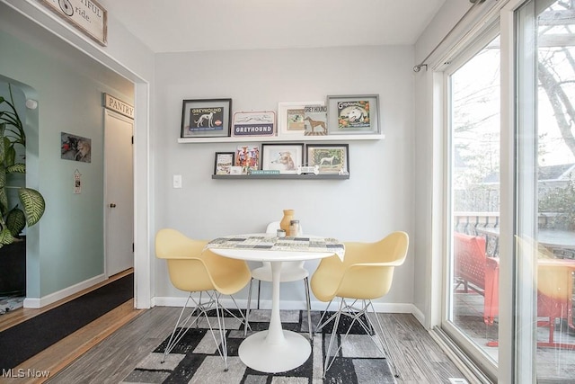 dining area with dark hardwood / wood-style floors