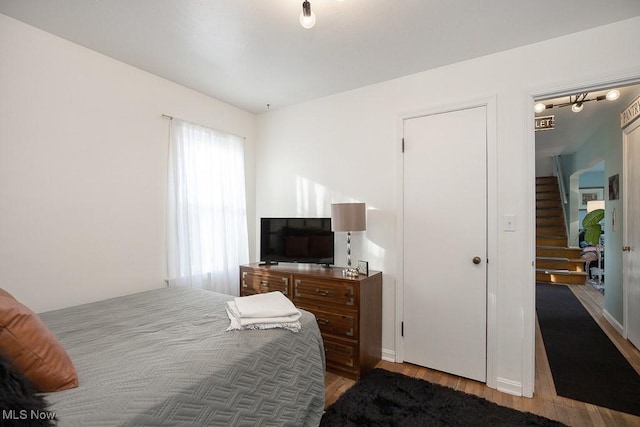 bedroom with hardwood / wood-style flooring