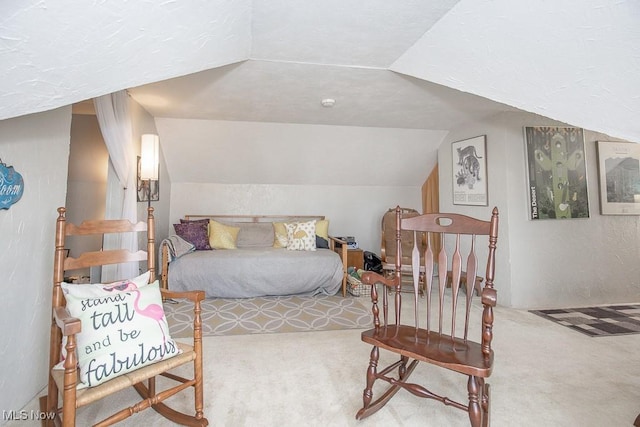 bedroom with carpet and lofted ceiling