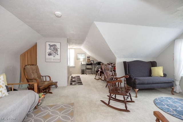 sitting room with light colored carpet and lofted ceiling