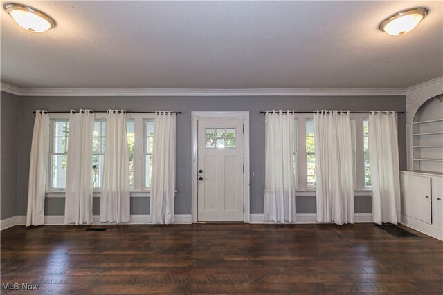 interior space featuring crown molding, dark hardwood / wood-style floors, and a textured ceiling