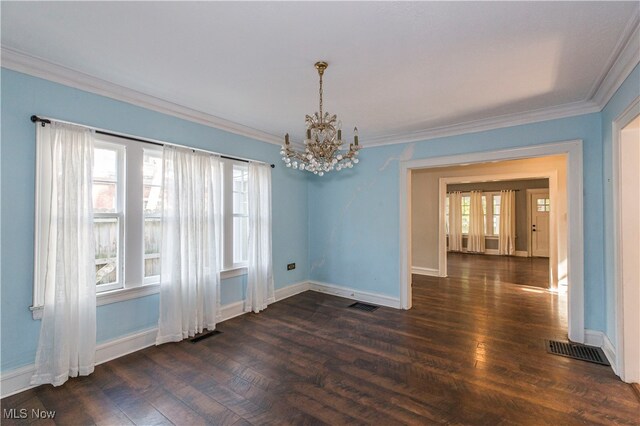 spare room featuring ornamental molding, a notable chandelier, and dark hardwood / wood-style flooring