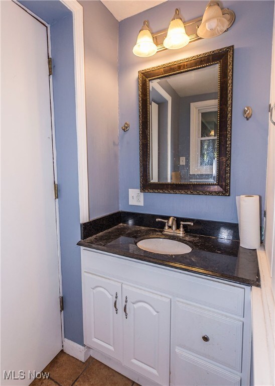 bathroom with tile patterned flooring and vanity