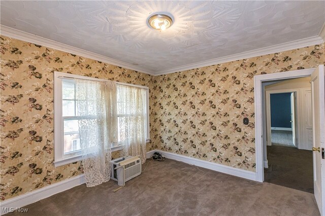 spare room with dark carpet, ornamental molding, and a wall unit AC