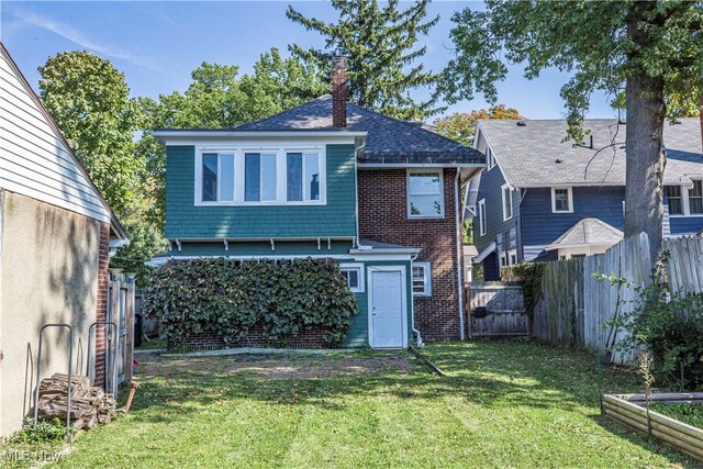 back of house featuring a yard