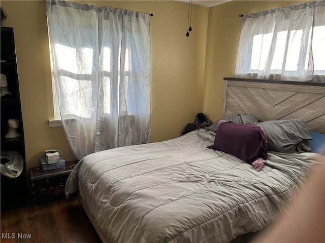 bedroom featuring dark hardwood / wood-style flooring