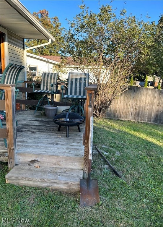 wooden terrace with a lawn