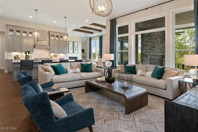 living room featuring a fireplace, plenty of natural light, and light wood-type flooring