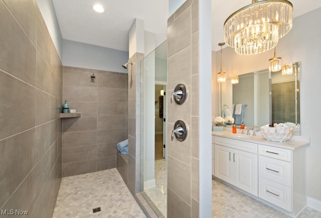 bathroom featuring vanity and tiled shower