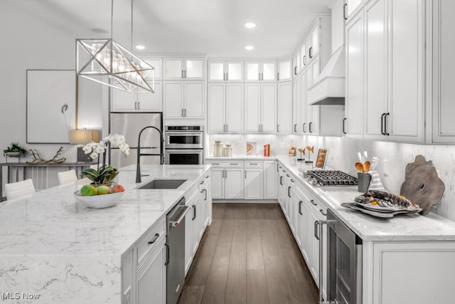 kitchen featuring light stone counters, pendant lighting, dark hardwood / wood-style flooring, and white cabinetry