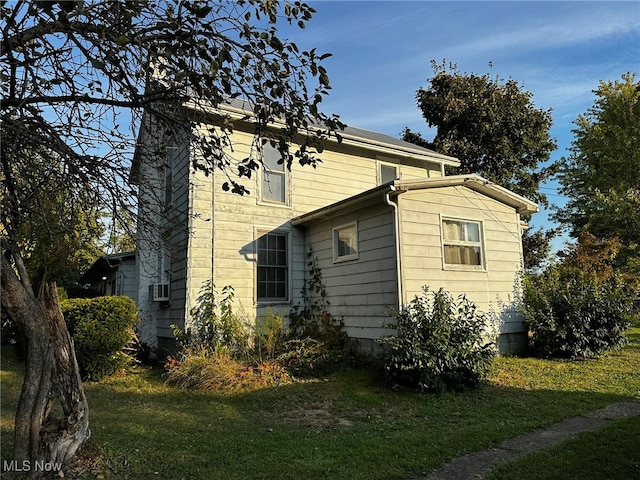 view of side of home featuring a lawn