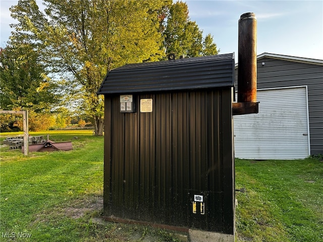 view of outbuilding with a yard