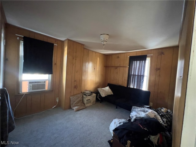 living room with light colored carpet, cooling unit, and wooden walls