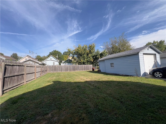 view of yard with a garage and an outdoor structure