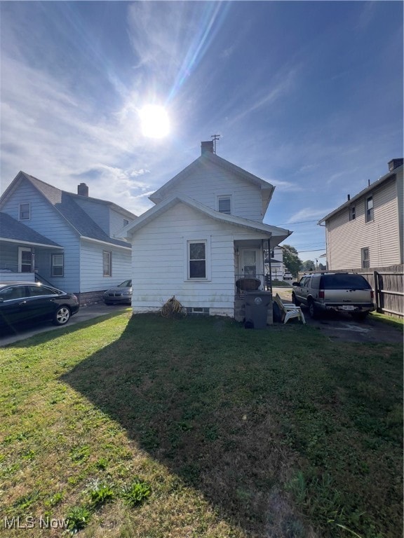 view of side of home featuring a lawn