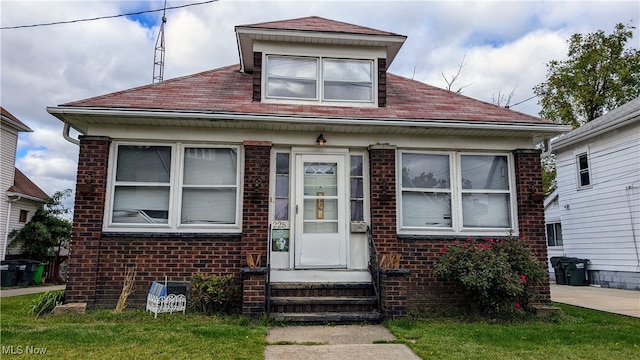 bungalow-style home featuring a front yard