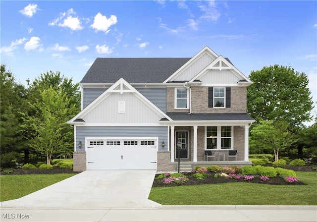 craftsman house featuring a garage, a porch, and a front yard