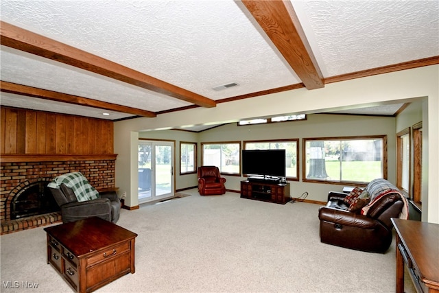 carpeted living room featuring a fireplace, beam ceiling, and a textured ceiling