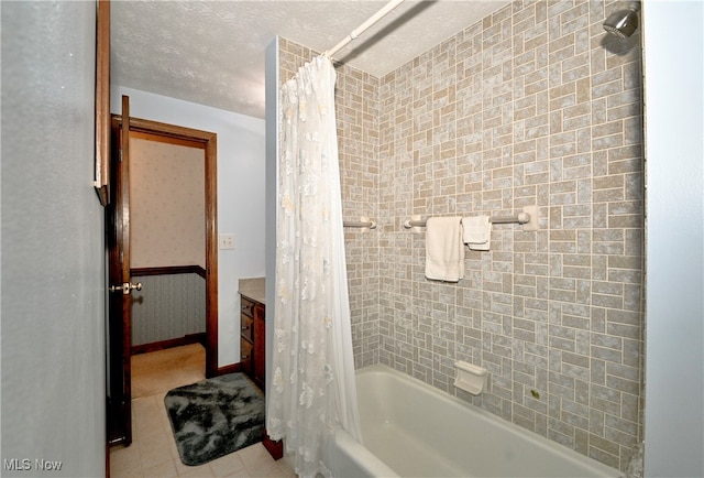 bathroom with vanity, shower / bathtub combination with curtain, and tile patterned floors