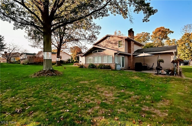 back of house featuring a patio and a lawn