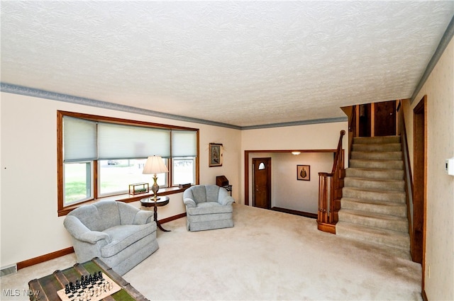 living room with ornamental molding, carpet flooring, and a textured ceiling