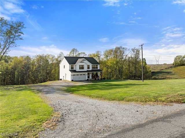 view of front of home featuring a front yard and a garage