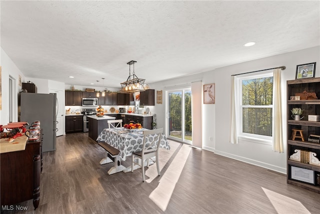 dining space featuring a textured ceiling, a chandelier, and dark hardwood / wood-style flooring