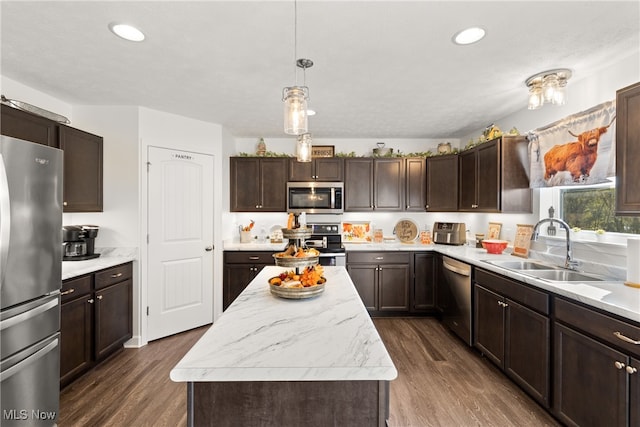 kitchen with stainless steel appliances, sink, dark hardwood / wood-style flooring, and a center island