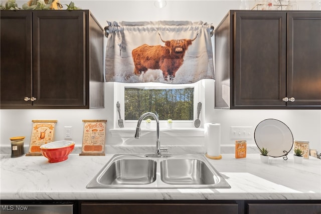 kitchen featuring dark brown cabinets and sink