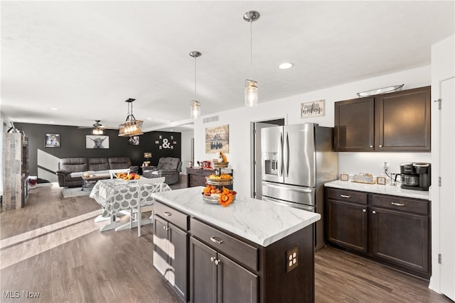 kitchen with dark brown cabinets, pendant lighting, stainless steel refrigerator with ice dispenser, and dark hardwood / wood-style flooring