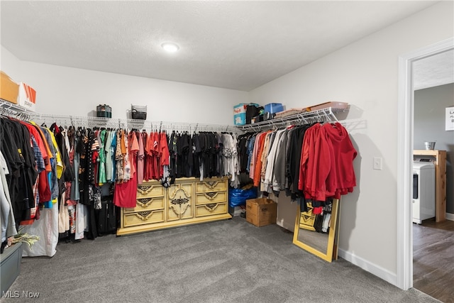 spacious closet with washer / dryer and carpet floors