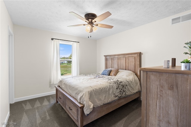 carpeted bedroom featuring ceiling fan and a textured ceiling