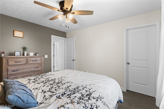 carpeted bedroom with ceiling fan and a textured ceiling