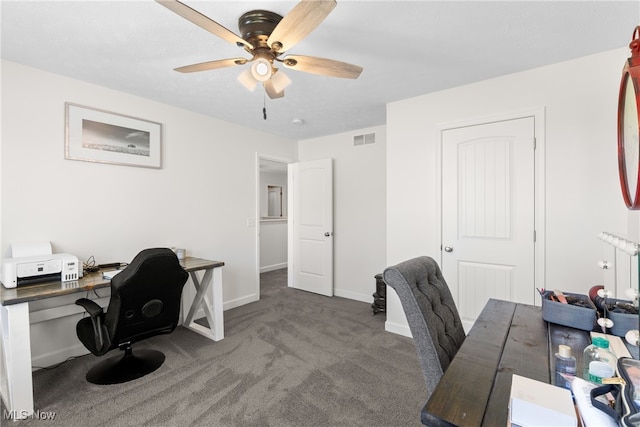 carpeted office space featuring ceiling fan