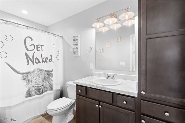 full bathroom with vanity, shower / bath combo with shower curtain, and toilet