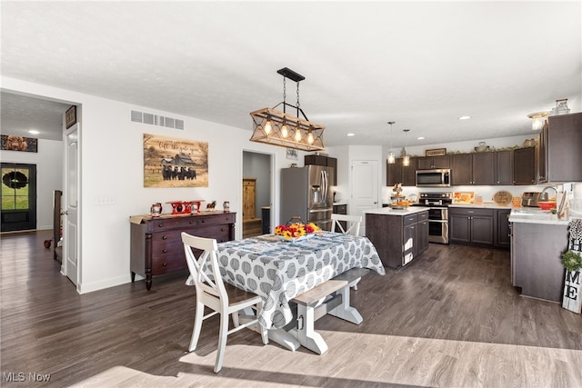 dining space featuring sink and dark hardwood / wood-style flooring