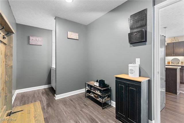 hall featuring dark hardwood / wood-style floors and a textured ceiling