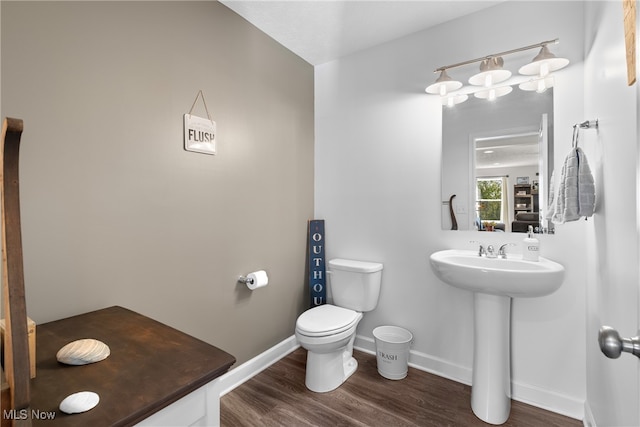 bathroom featuring hardwood / wood-style flooring, sink, and toilet