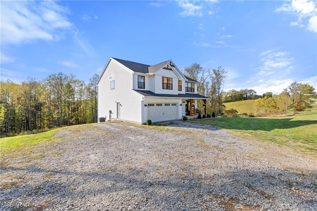 view of side of property featuring a lawn and a garage