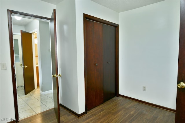 unfurnished bedroom with wood-type flooring and a closet