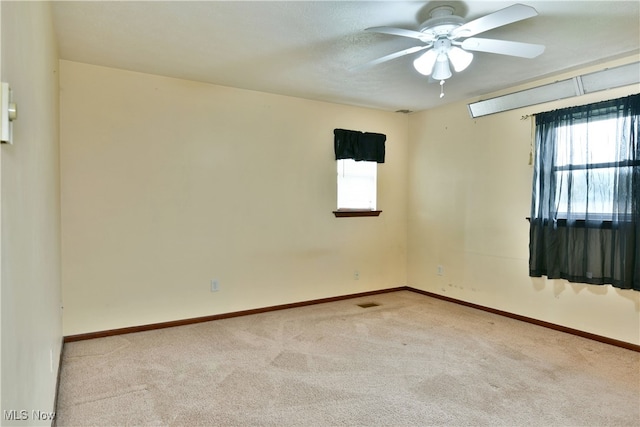 spare room with light carpet and ceiling fan