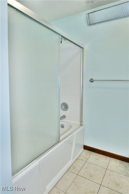 bathroom featuring combined bath / shower with glass door and tile patterned flooring