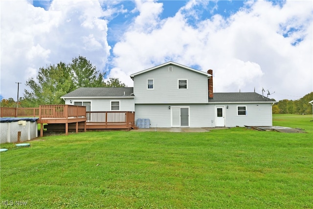 back of house with cooling unit, a yard, and a deck