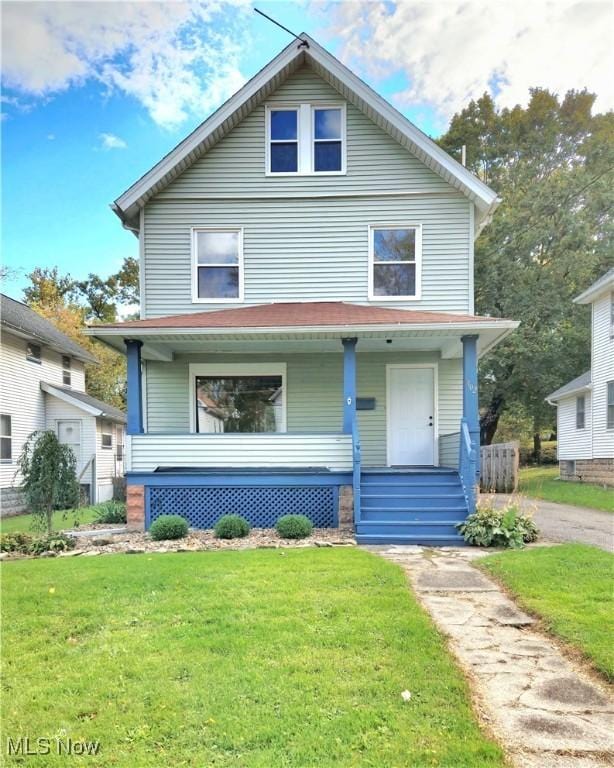 view of front of property featuring covered porch and a front lawn