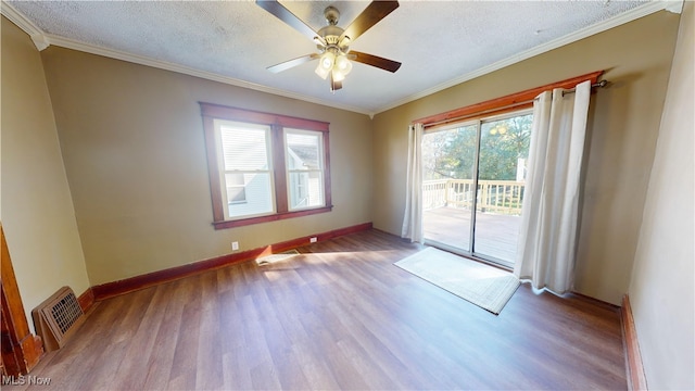 spare room featuring a textured ceiling, light hardwood / wood-style flooring, and ornamental molding