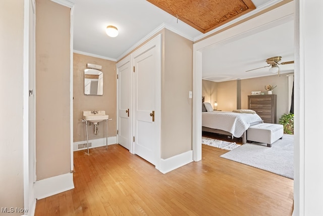 hall featuring ornamental molding and hardwood / wood-style floors