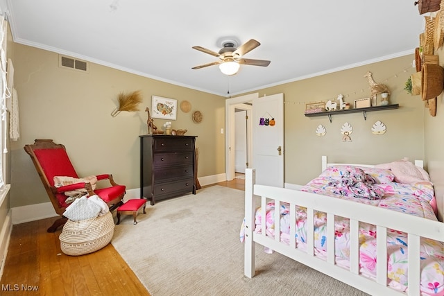 bedroom featuring crown molding, ceiling fan, and hardwood / wood-style floors