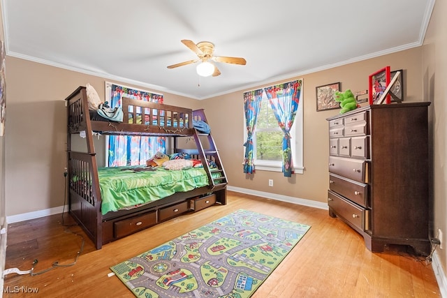 bedroom featuring ornamental molding, hardwood / wood-style flooring, and ceiling fan